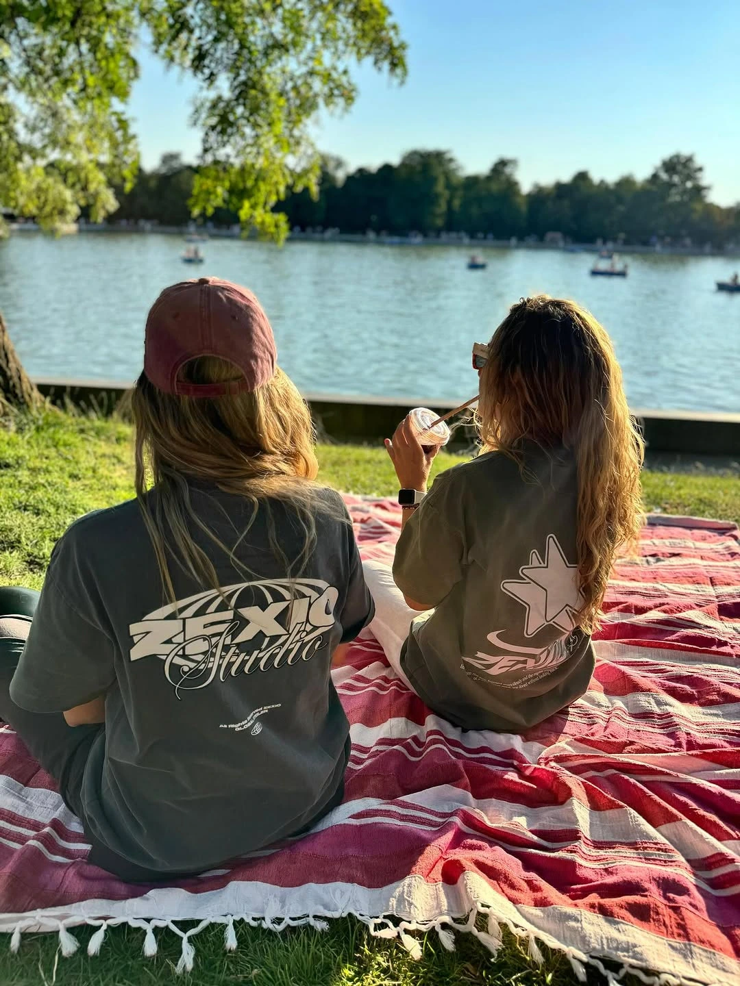 Dos mujeres en el parque del retiro llevando camiseta de Zexio